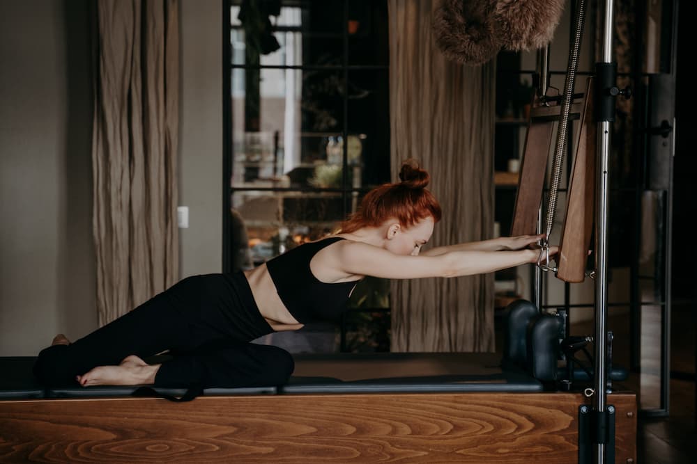 flexible-ginger-woman-stretching-arms-on-cadillac-2026-01-08-07-38-10-utc-1.jpg